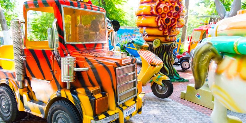 Big truck on a children's carousel in an amusement park.